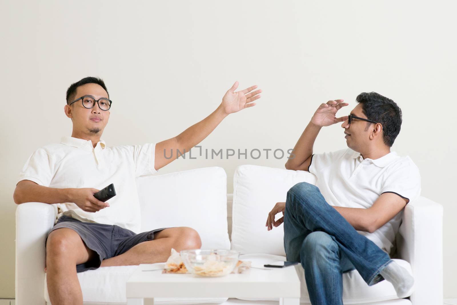 Men arguing. Two male friend having argument at home. Multiracial people friendship.