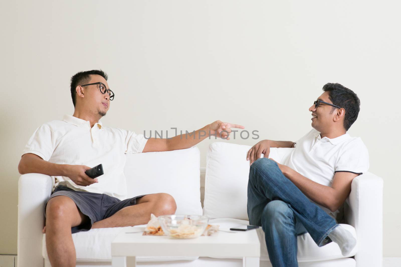 Men arguing. Two middle aged male friend having argument at home. Multiracial people friendship.