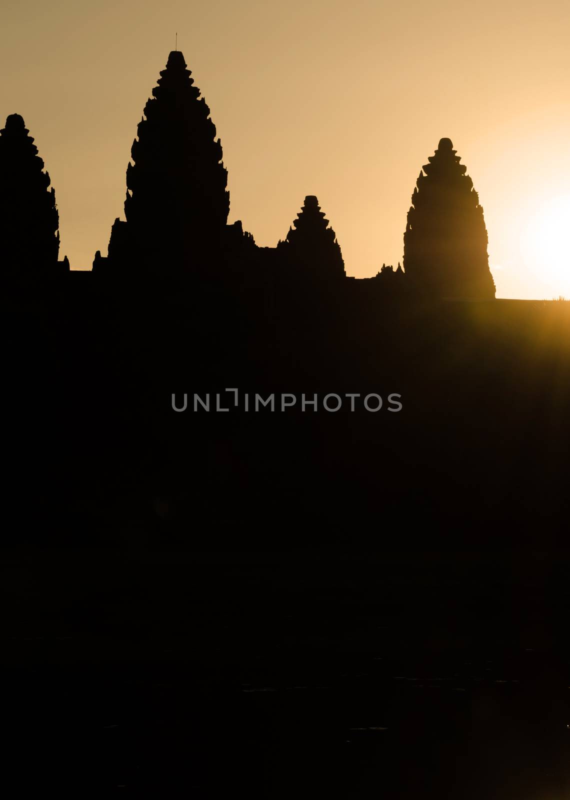 Silhouette of Angkor Wat at sunrise by siraanamwong