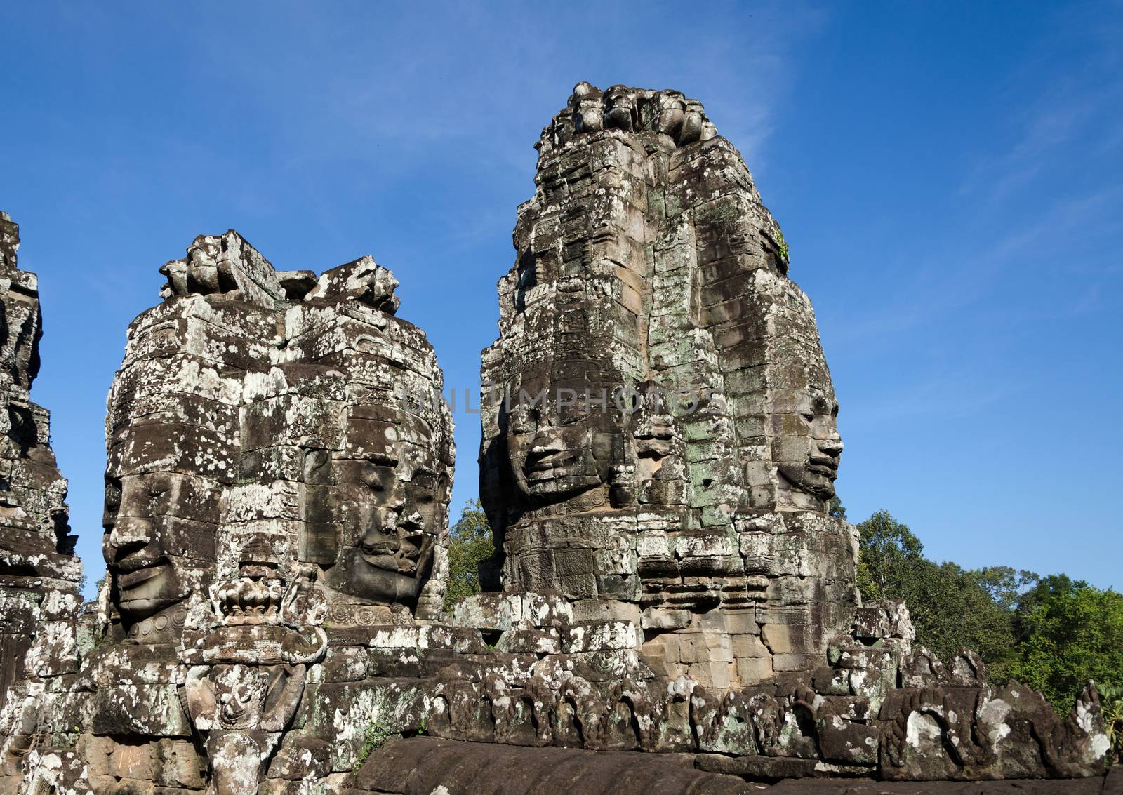 Faces of Bayon temple in Angkor Thom by siraanamwong