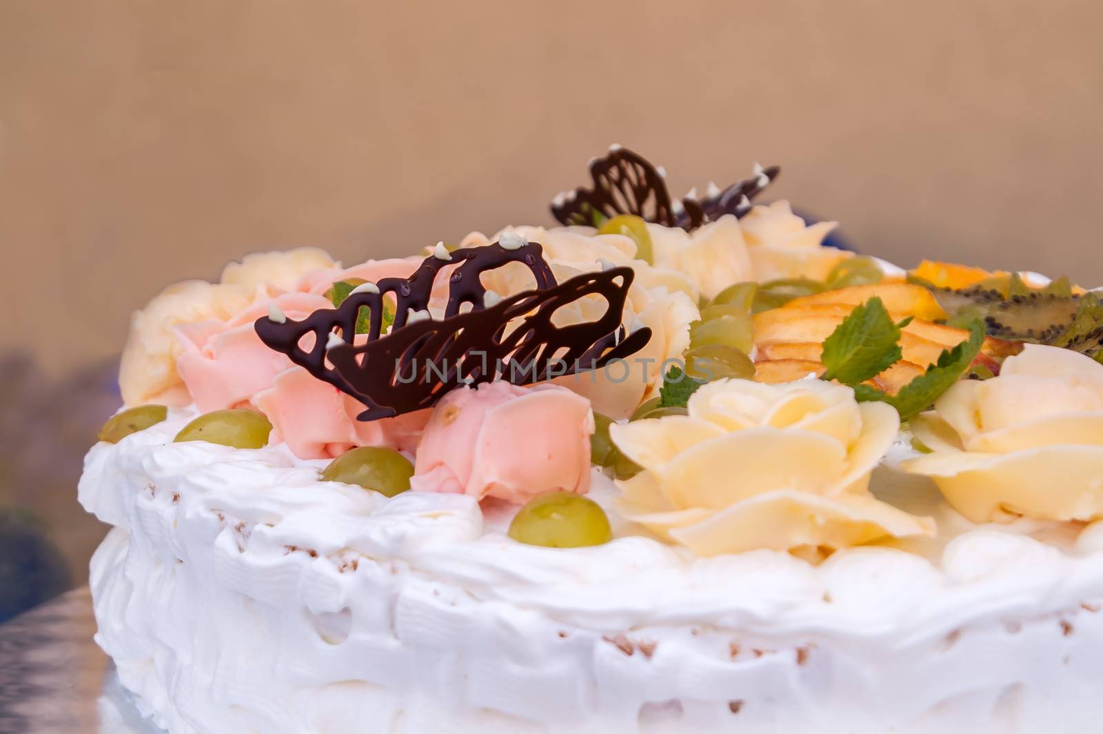 delicious white cake decorated with multicolored roses 