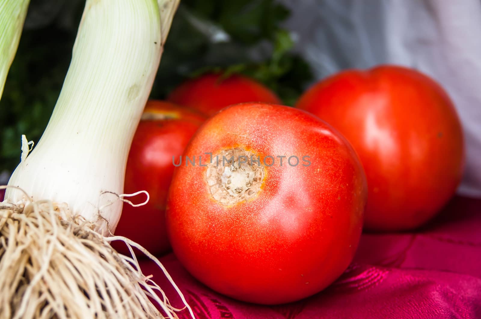 few red tomato close-up with green onions by antonius_