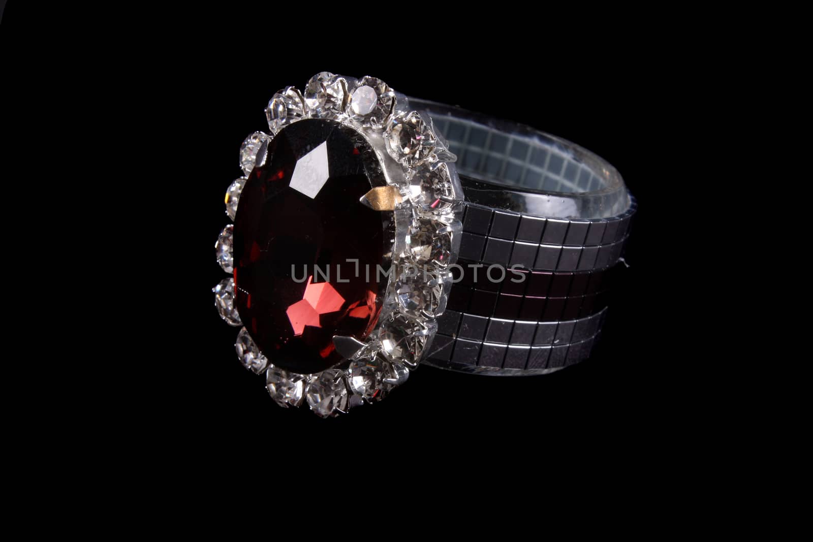 A luxurious tissue holder made of silver and studded with a red gemstone