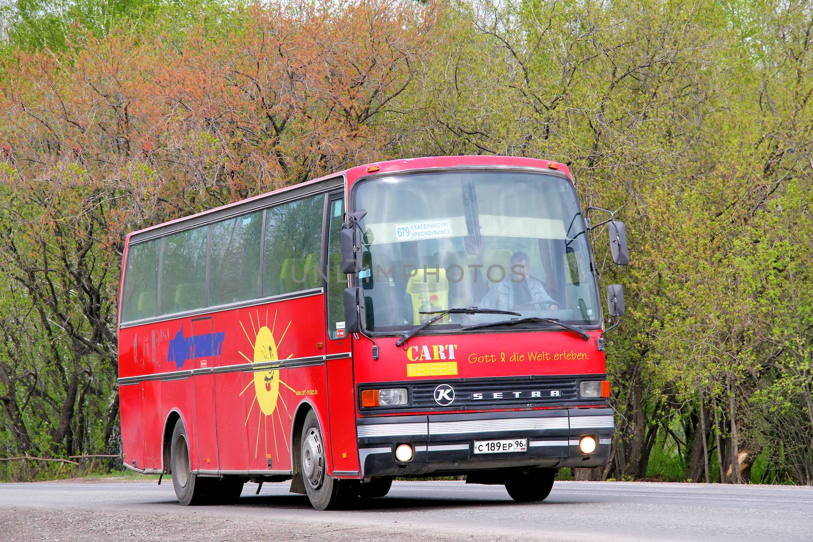 SVERDLOVSK REGION, RUSSIA - MAY 9, 2012: Red Setra S211HD interurban coach at the interurban road.