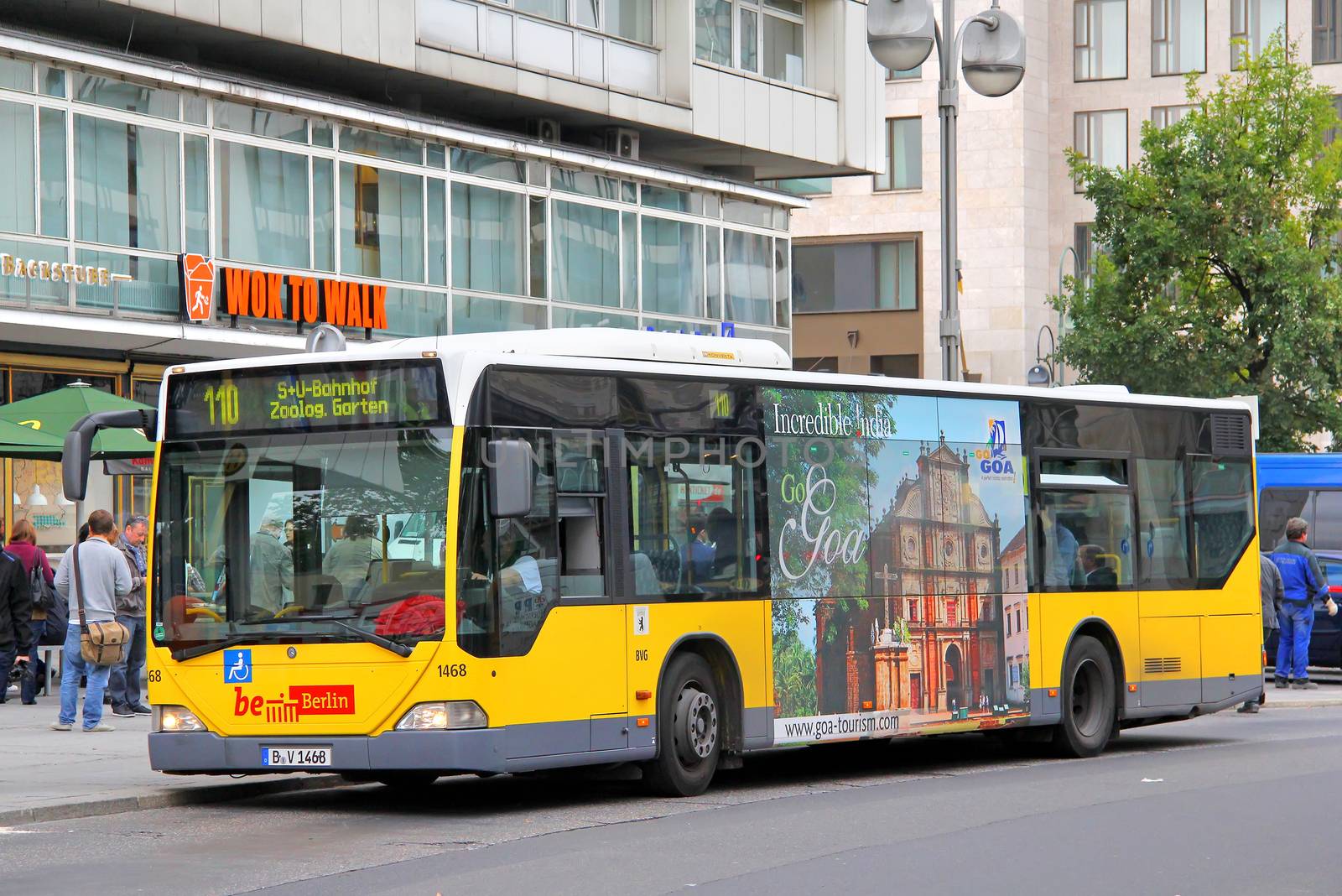 BERLIN, GERMANY - SEPTEMBER 11, 2013: Yellow Mercedes-Benz O530 Citaro city bus of Berliner Verkehrsbetriebe bus company at the city street.