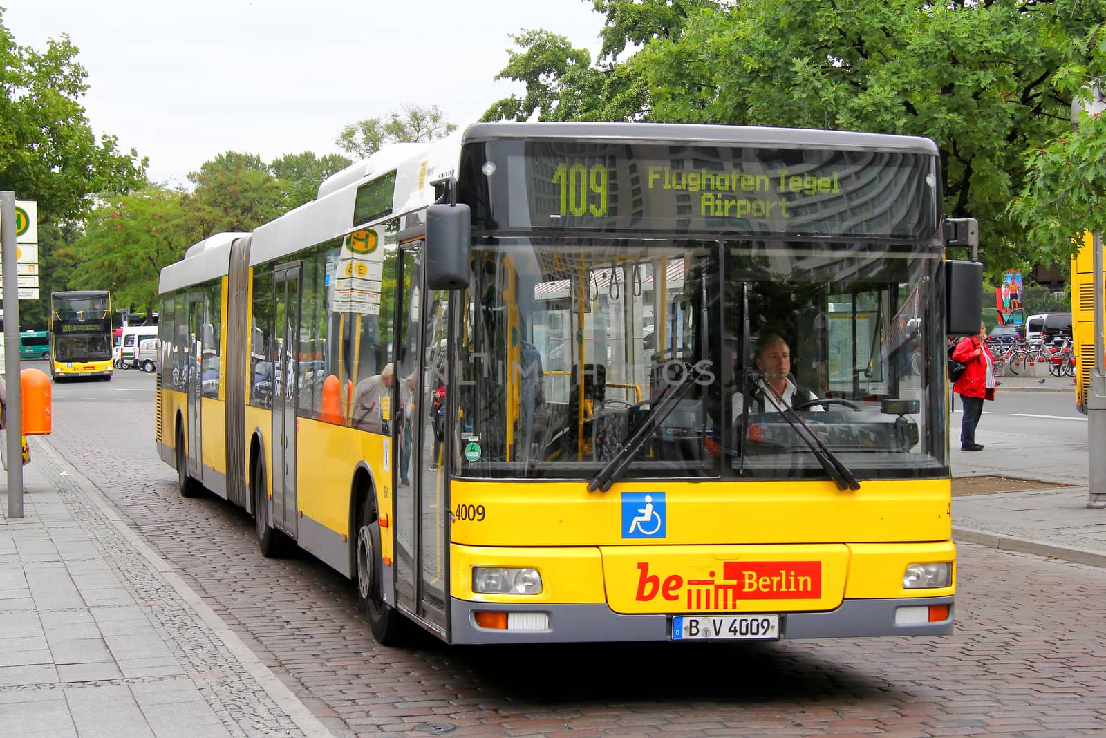 BERLIN, GERMANY - SEPTEMBER 10, 2013: Yellow MAN A23 NG313 articulated city bus of the Berliner Verkehrsbetriebe bus company at the city street.