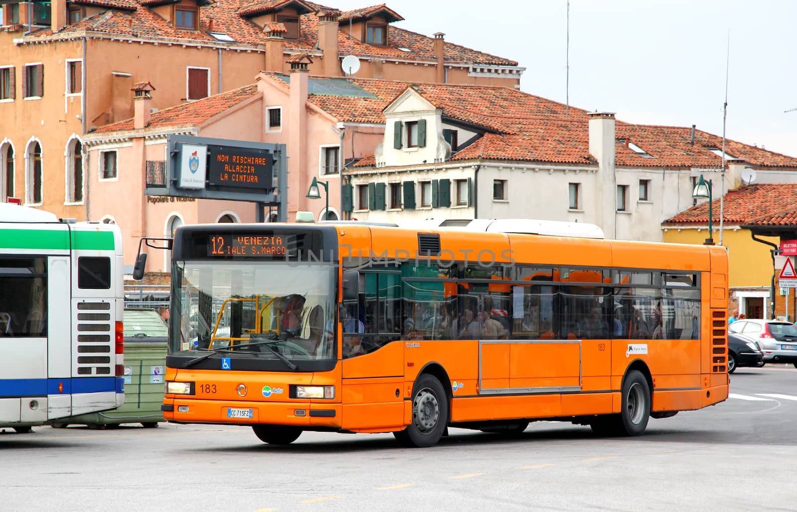 VENICE, ITALY - JULY 30, 2014: Orange city bus Irisbus CityClass at the city street.