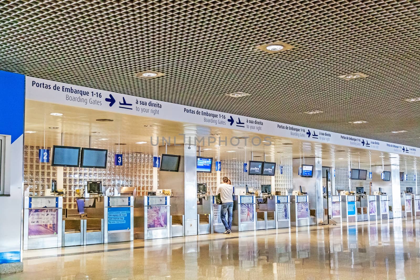 Santa Cruz, Madeira - June 9, 2013: Check-in at airport of the island Madeira. Man standing at the counter talking to ground staff.