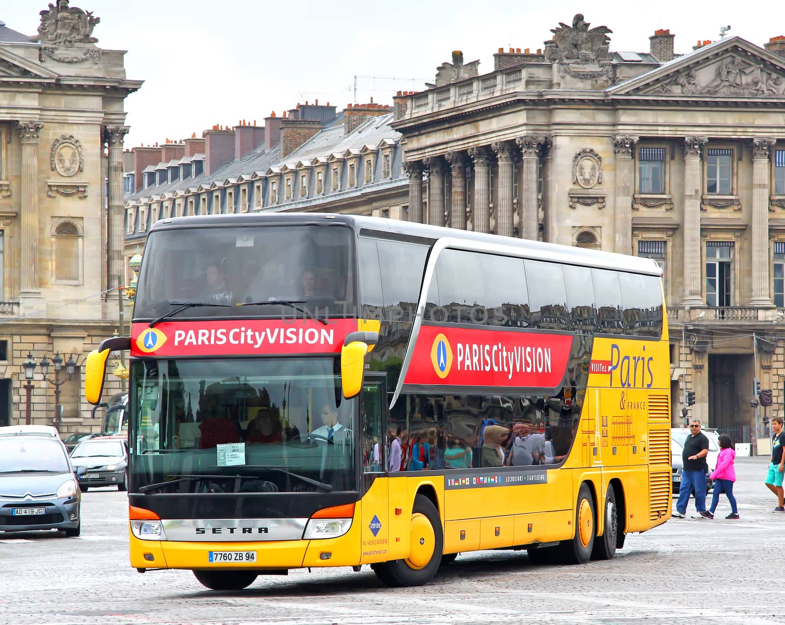 PARIS, FRANCE - AUGUST 8, 2014: Yellow city sightseeing bus Setra S431DT at the city street.