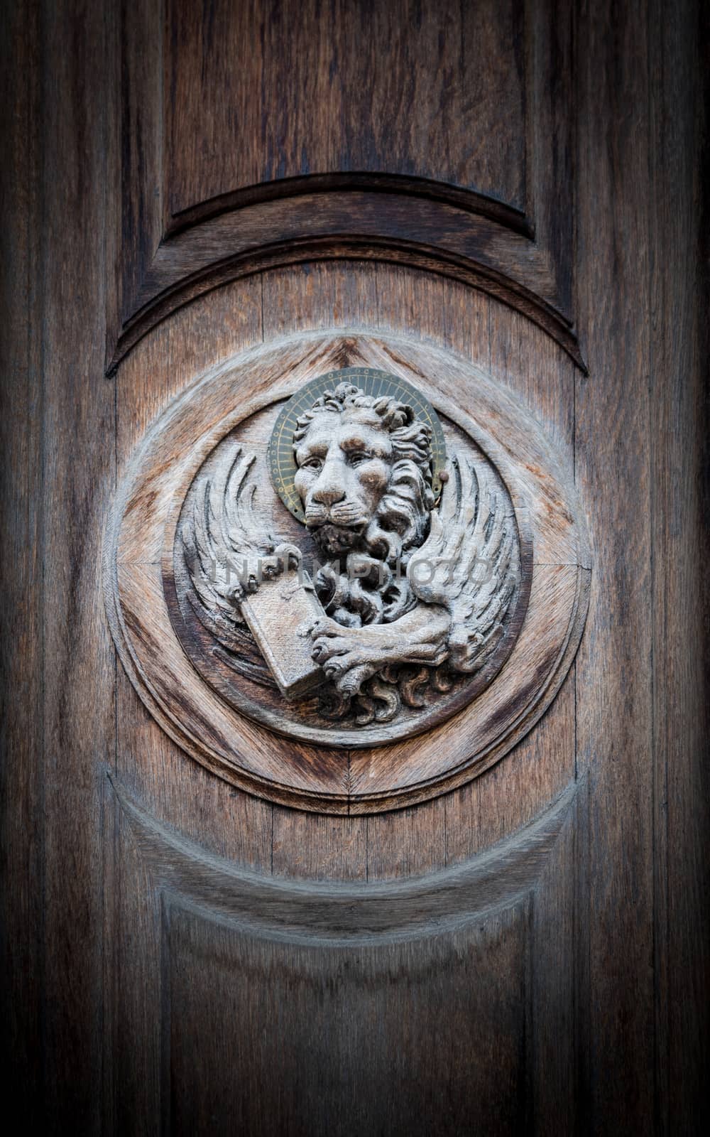 The winged lion of St. Mark, the symbol of the Venetian Republic, engraved on a portal of an old church.