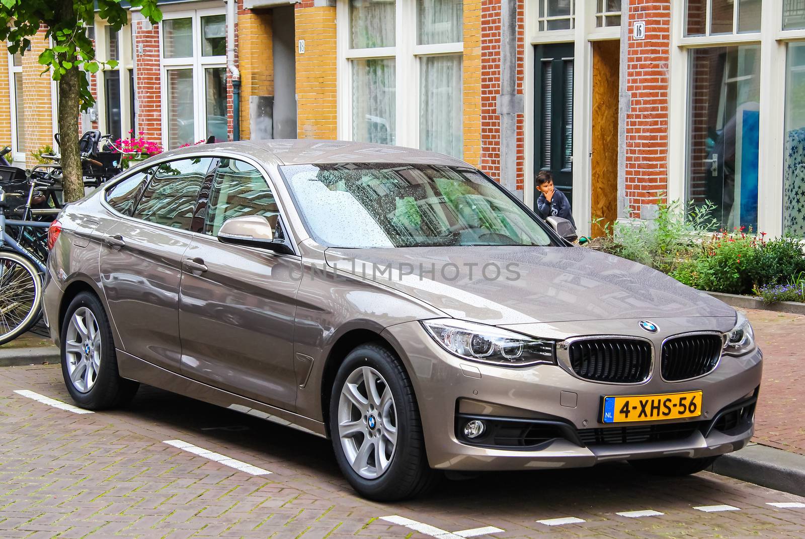 AMSTERDAM, NETHERLANDS - AUGUST 10, 2014: Motor car BMW F34 3-series GT at the city street.