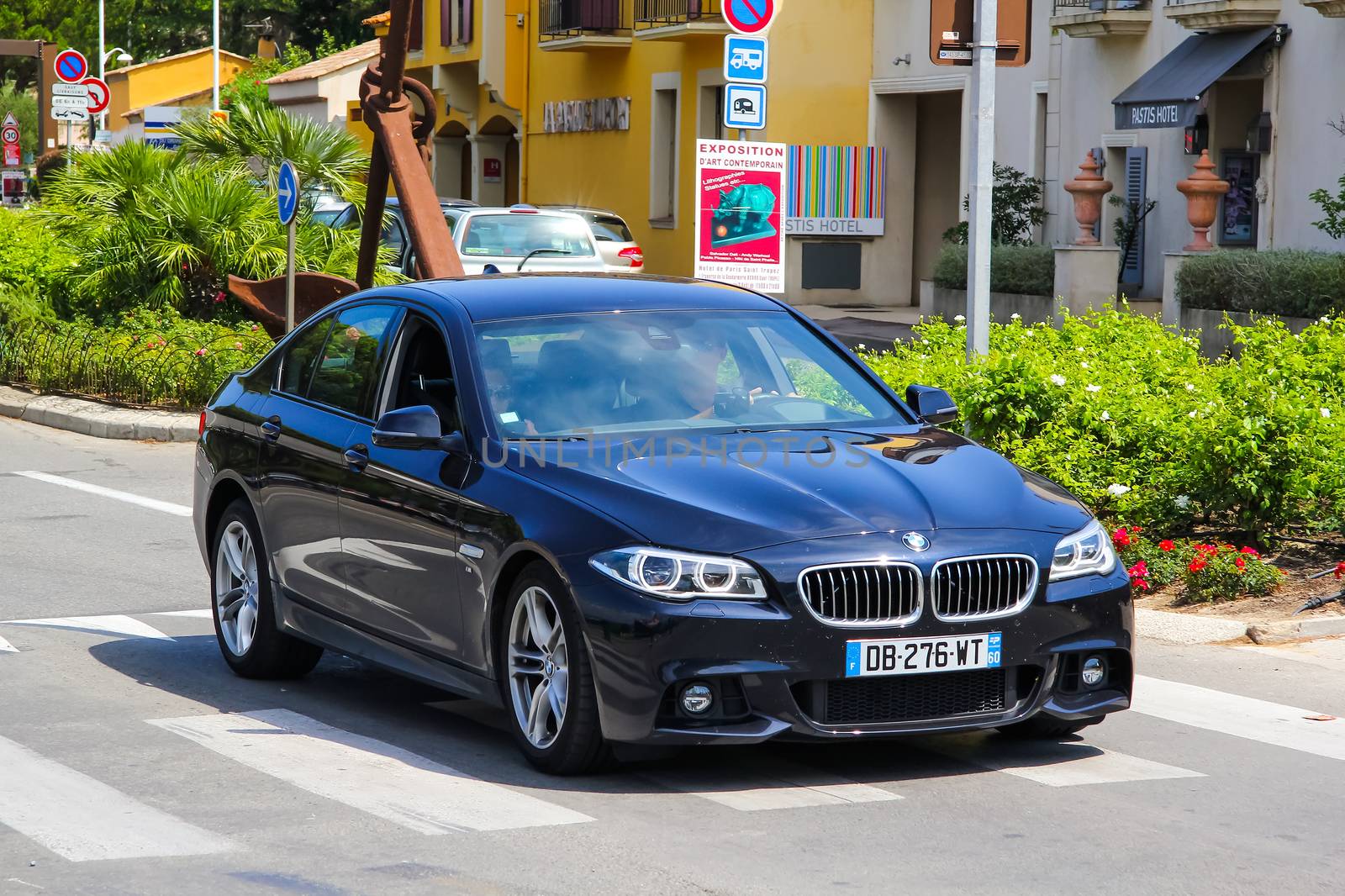 SAINT-TROPEZ, FRANCE - AUGUST 3, 2014: Motor car BMW F10 5-series at the city street.