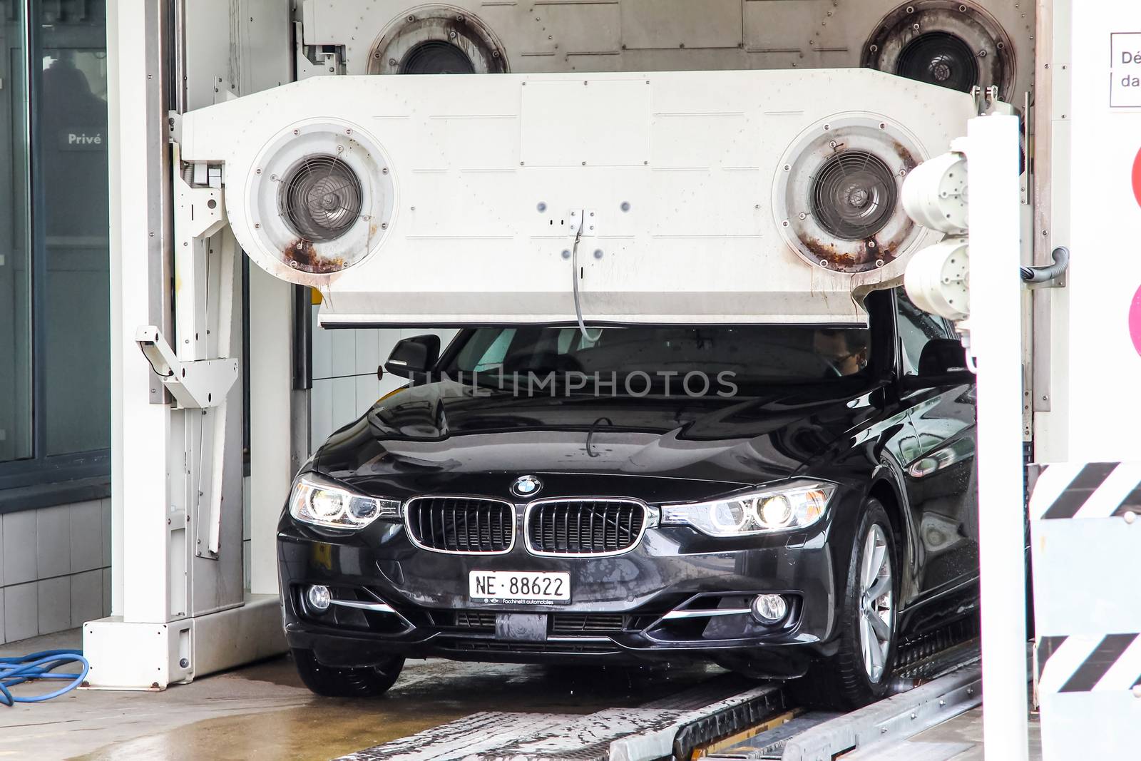 MONTREUX, SWITZERLAND - AUGUST 6, 2014: Motor car BMW F30 3-series at the car wash service station.