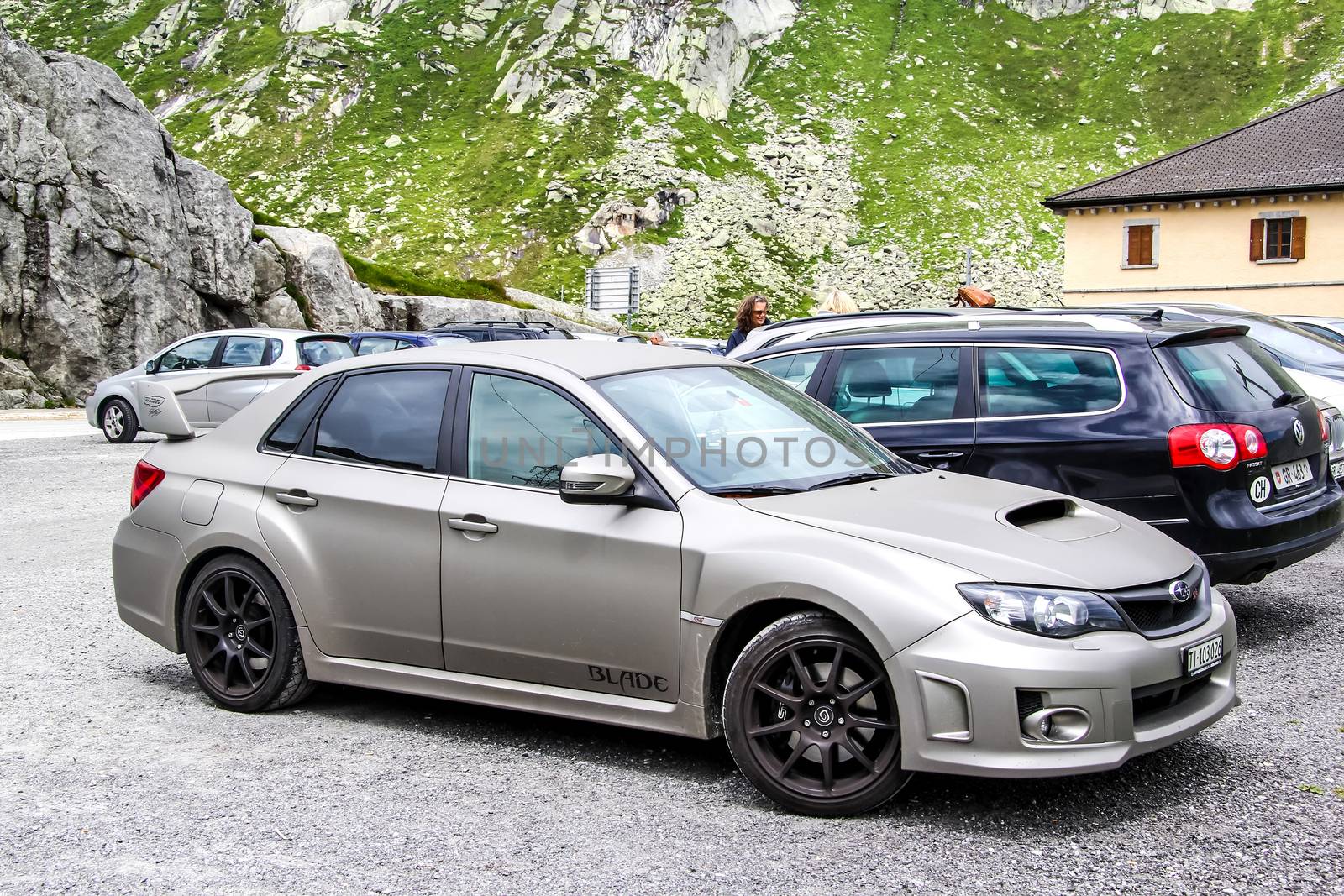 GOTTHARD PASS, SWITZERLAND - AUGUST 5, 2014: Motor car Subaru Impreza at the high Alpine mountain road.