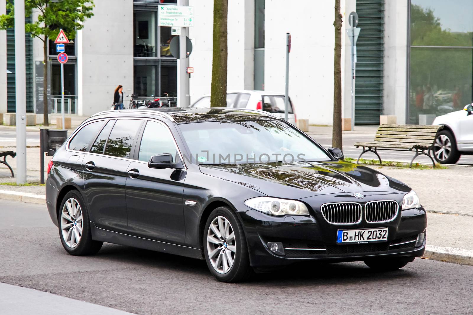 BERLIN, GERMANY - SEPTEMBER 10, 2013: Motor car BMW F11 5-series at the city street.