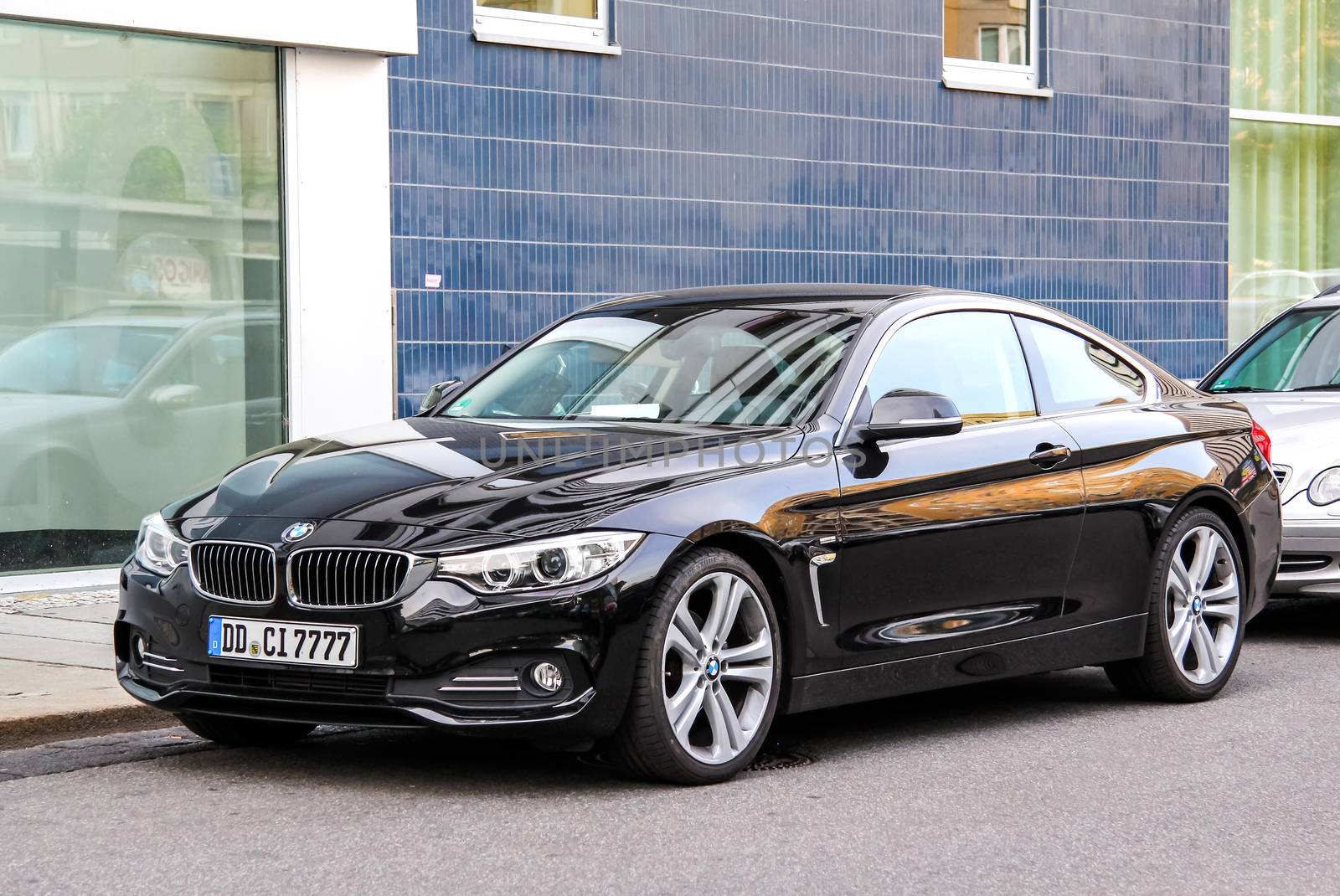 DRESDEN, GERMANY - JULY 20, 2014: Black sports car BMW F32 4-series at the city street.