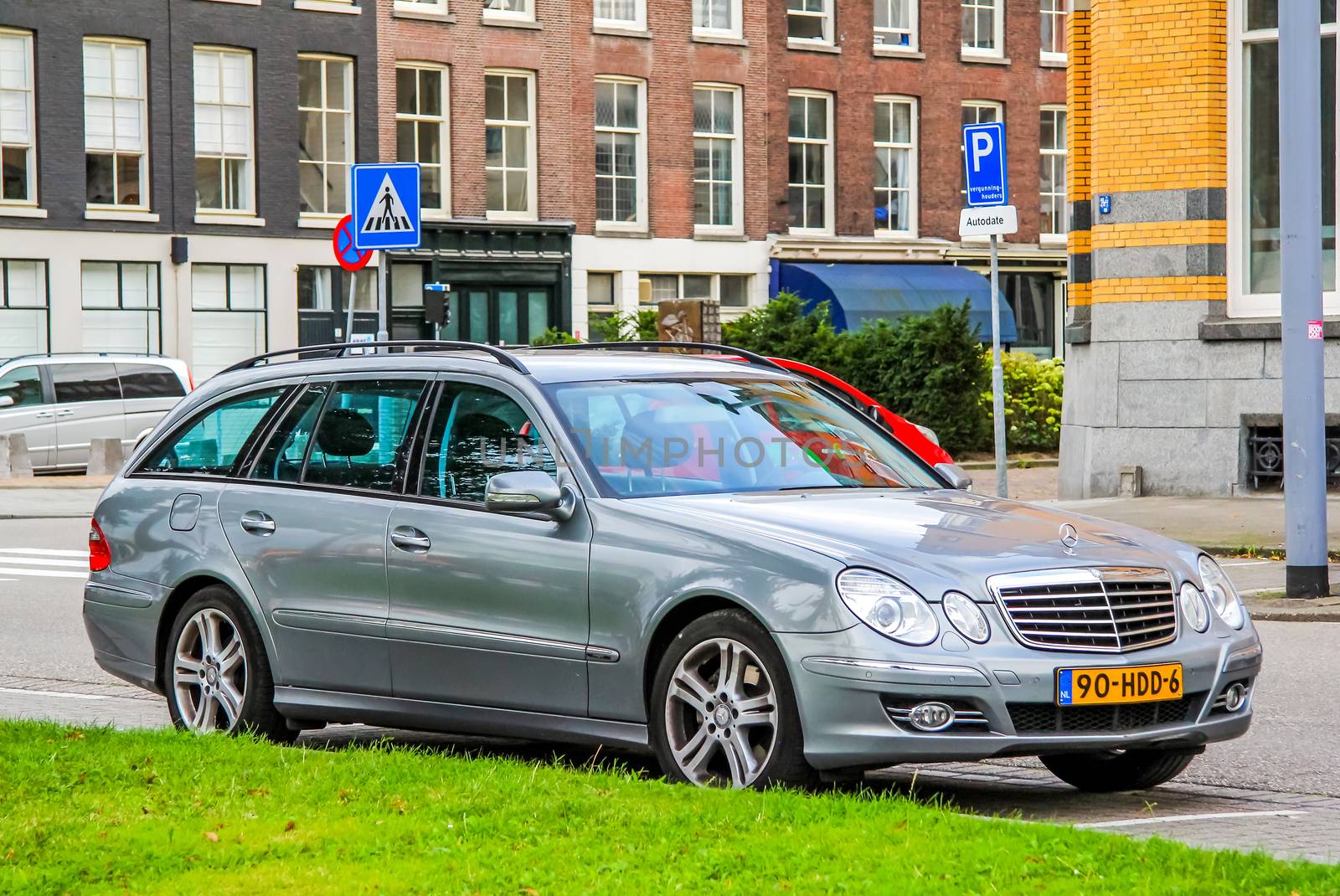 ROTTERDAM, NETHERLANDS - AUGUST 9, 2014: Motor car Mercedes-Benz S211 E-class at the city street.