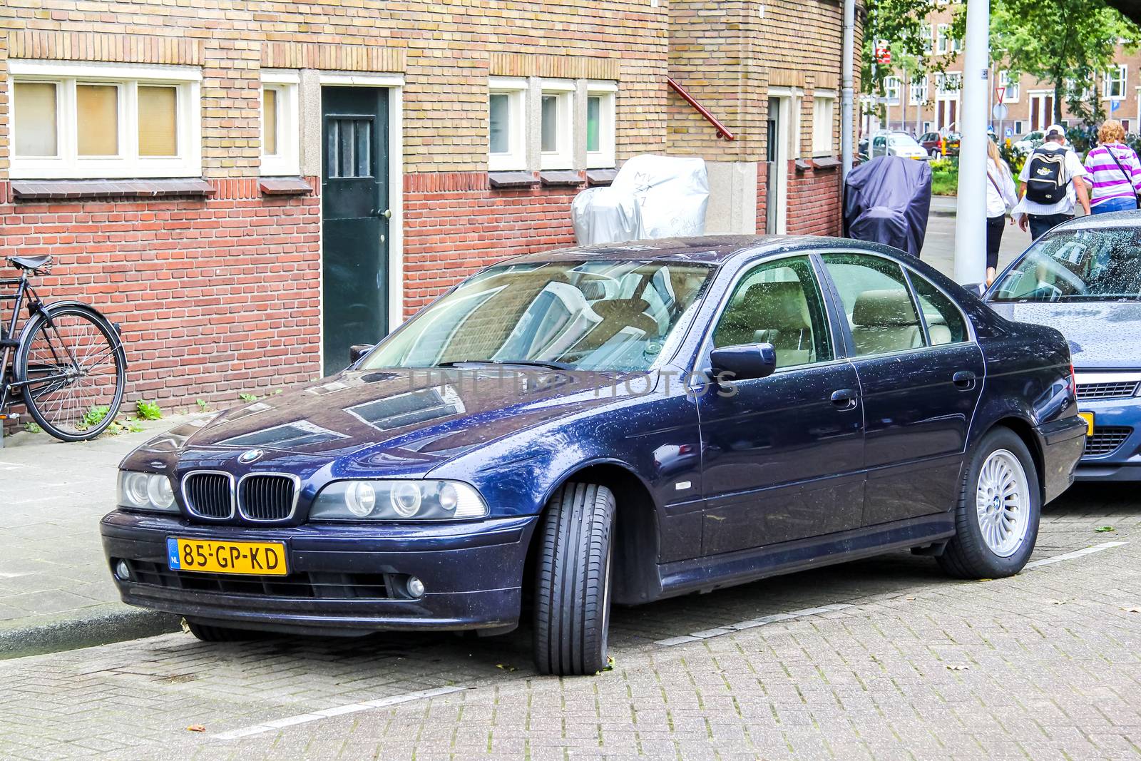 AMSTERDAM, NETHERLANDS - AUGUST 10, 2014: Motor car BMW E39 5-series at the city street.
