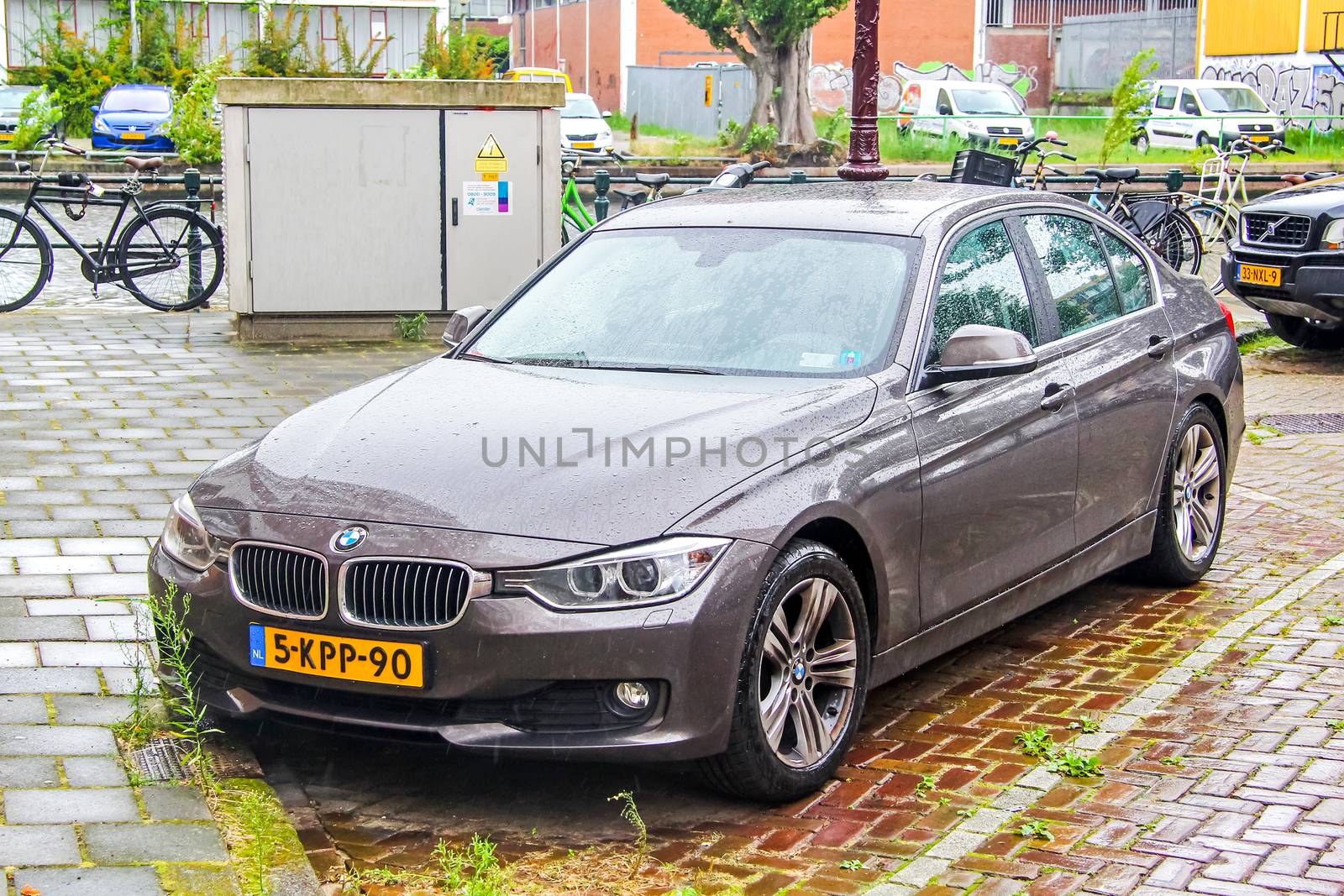 AMSTERDAM, NETHERLANDS - AUGUST 10, 2014: Motor car BMW F30 3-series at the city street.