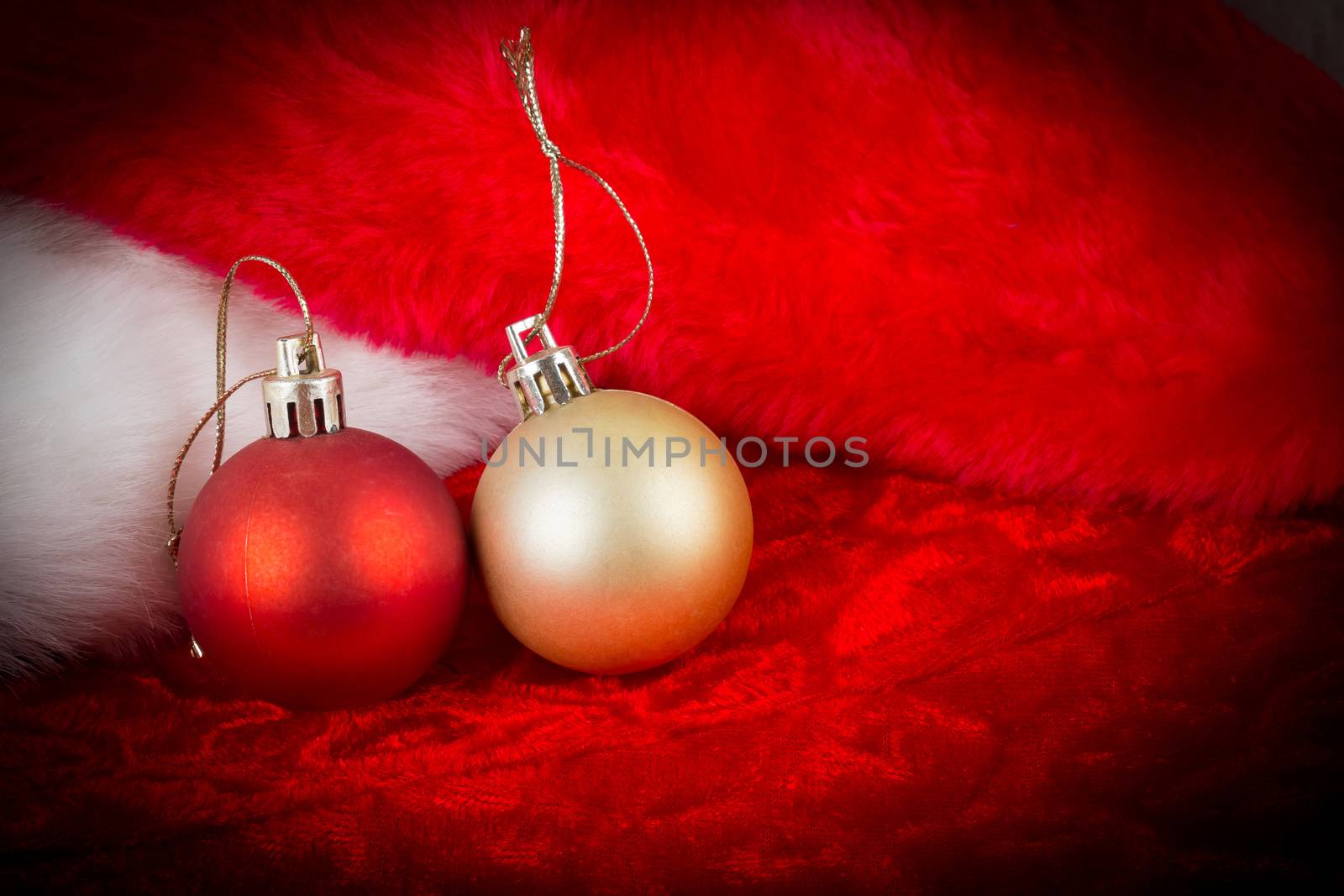 gold and red ball on Santa Claus hat  with dark vignette