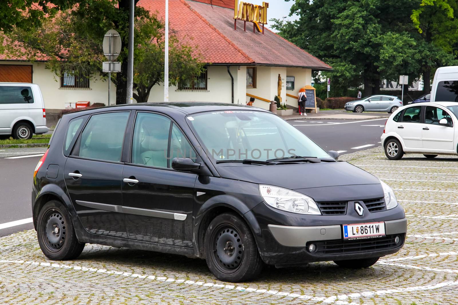 TYROL, AUSTRIA - JULY 28, 2014: Motor car Renault Scenic at the parking near the interurban freeway.