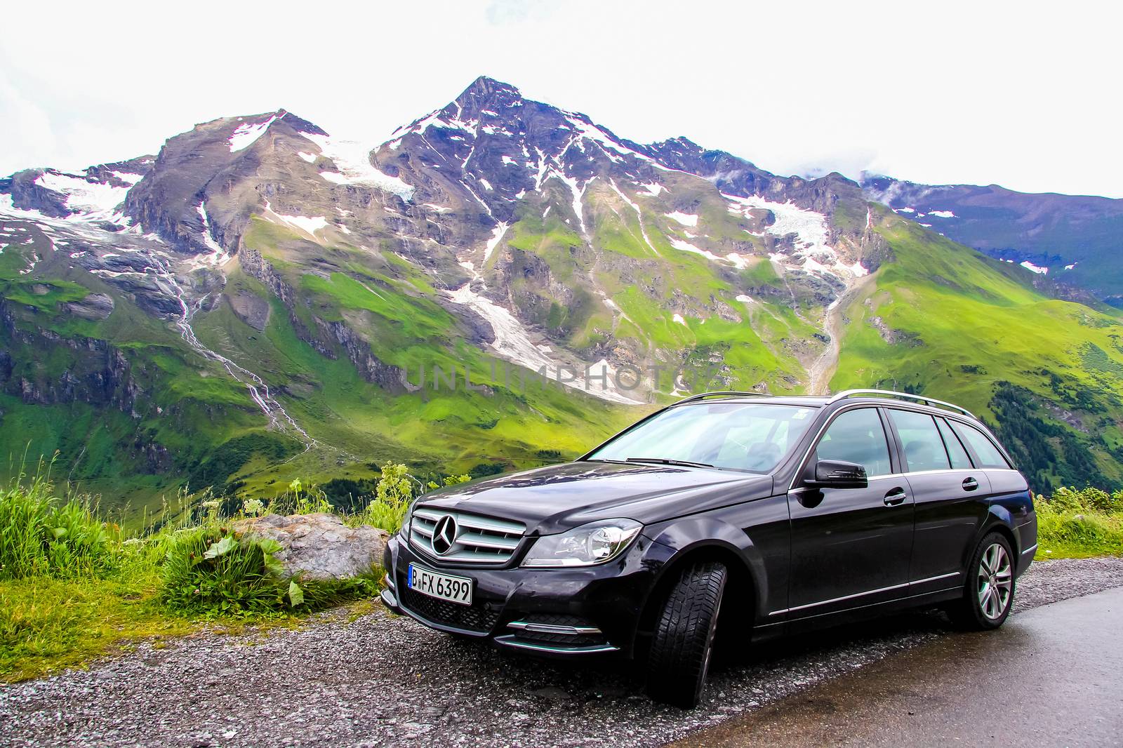 TYROL, AUSTRIA - JULY 29, 2014: Black estate car Mercedes-Benz W204 C180 at the Grossglockner High Alpine road.