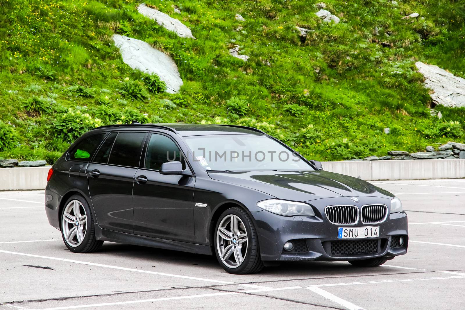 TYROL, AUSTRIA - JULY 29, 2014: Motor car BMW F11 5-series at the Grossglockner High Alpine road.