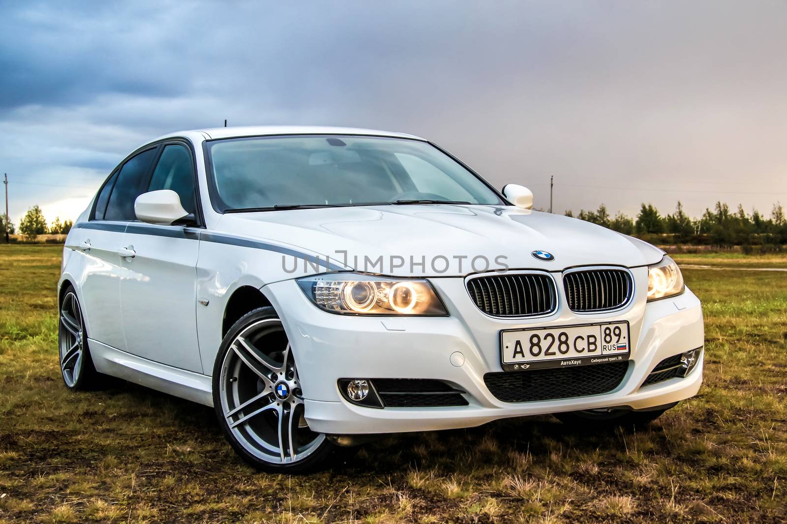 NOVYY URENGOY, RUSSIA - AUGUST 21, 2015: Motor car BMW E90 318i at the countryside.