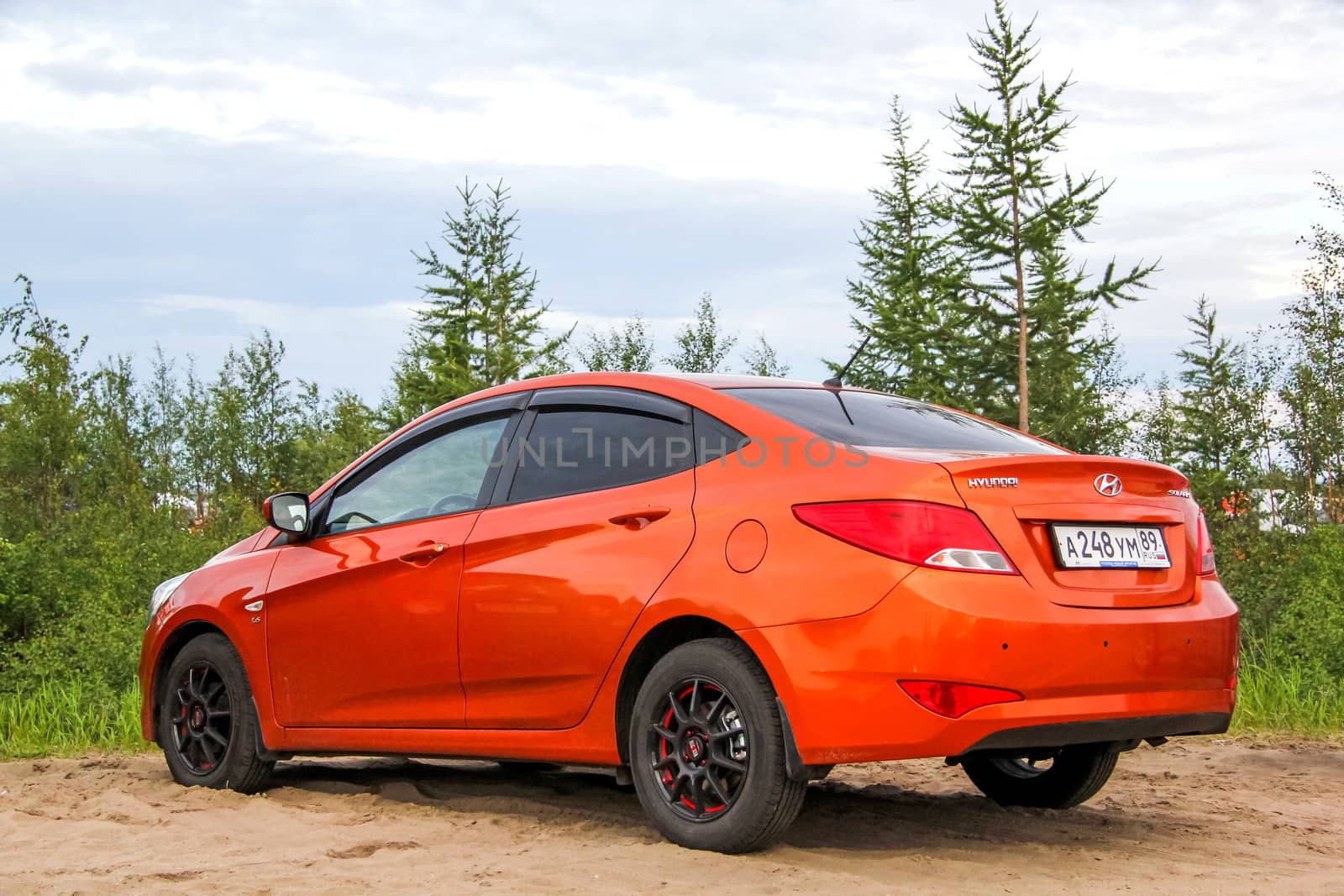 NOVYY URENGOY, RUSSIA - JUNE 27, 2015: Motor car Hyundai Solaris at the countryside.