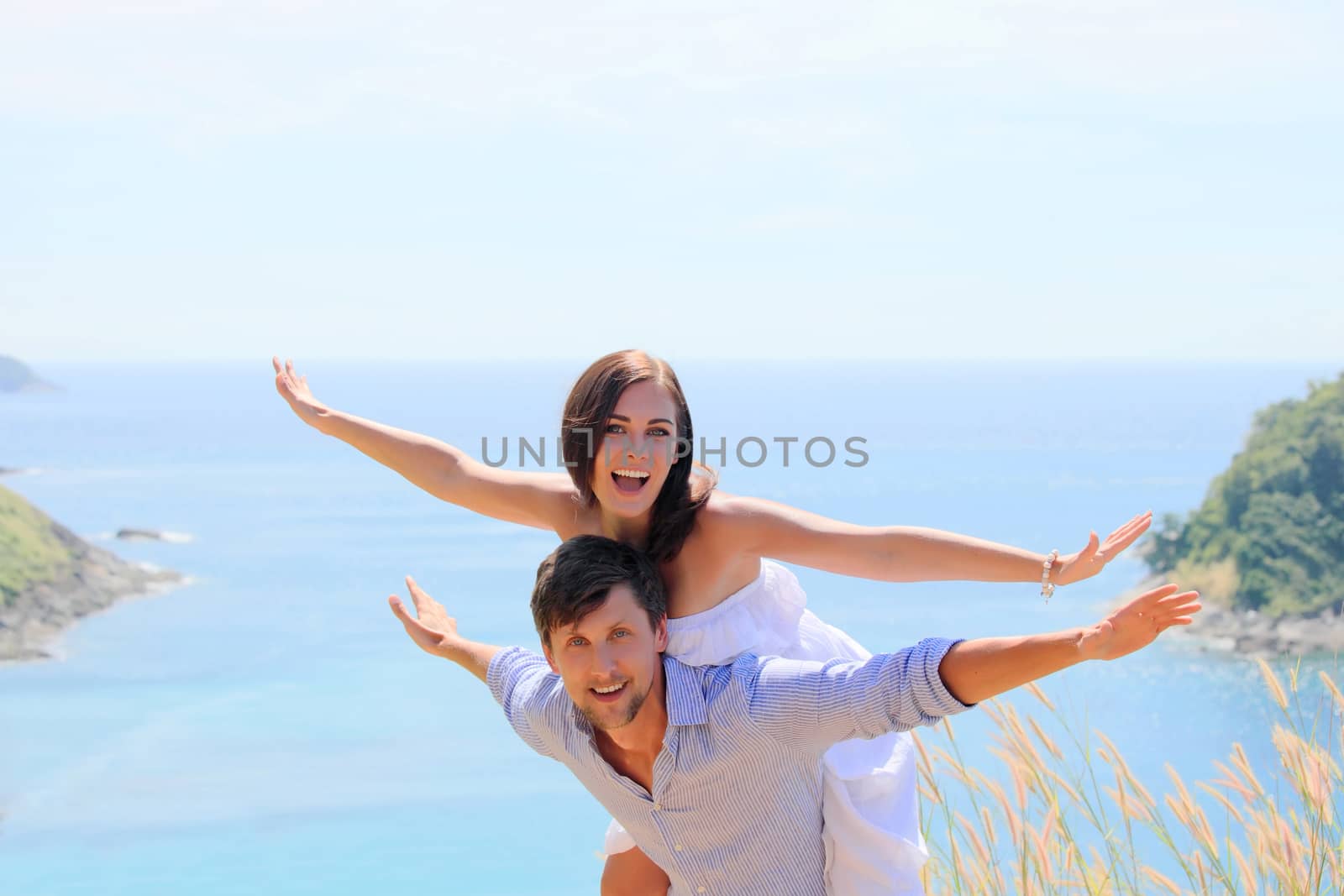 Cheerful couple having fun on vacation at seaside