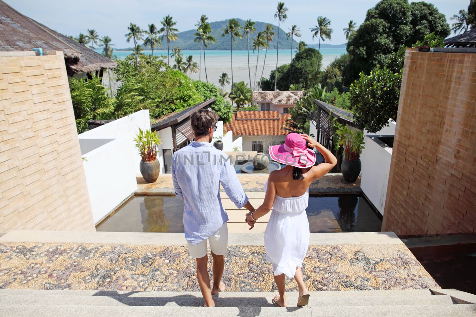 Young couple look at tourist resort and sea