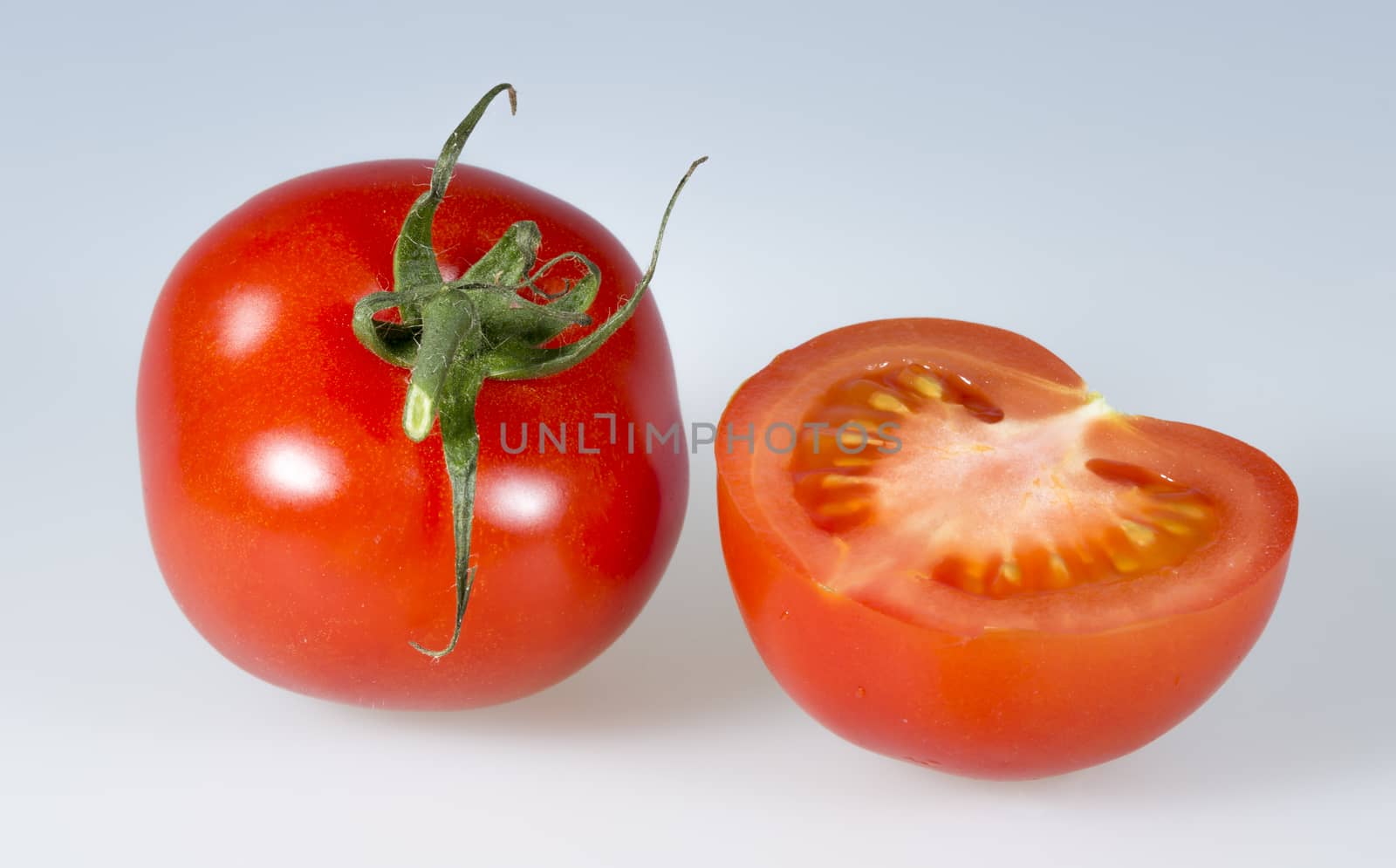 Tomatoes Close Up. One whole and one cut.