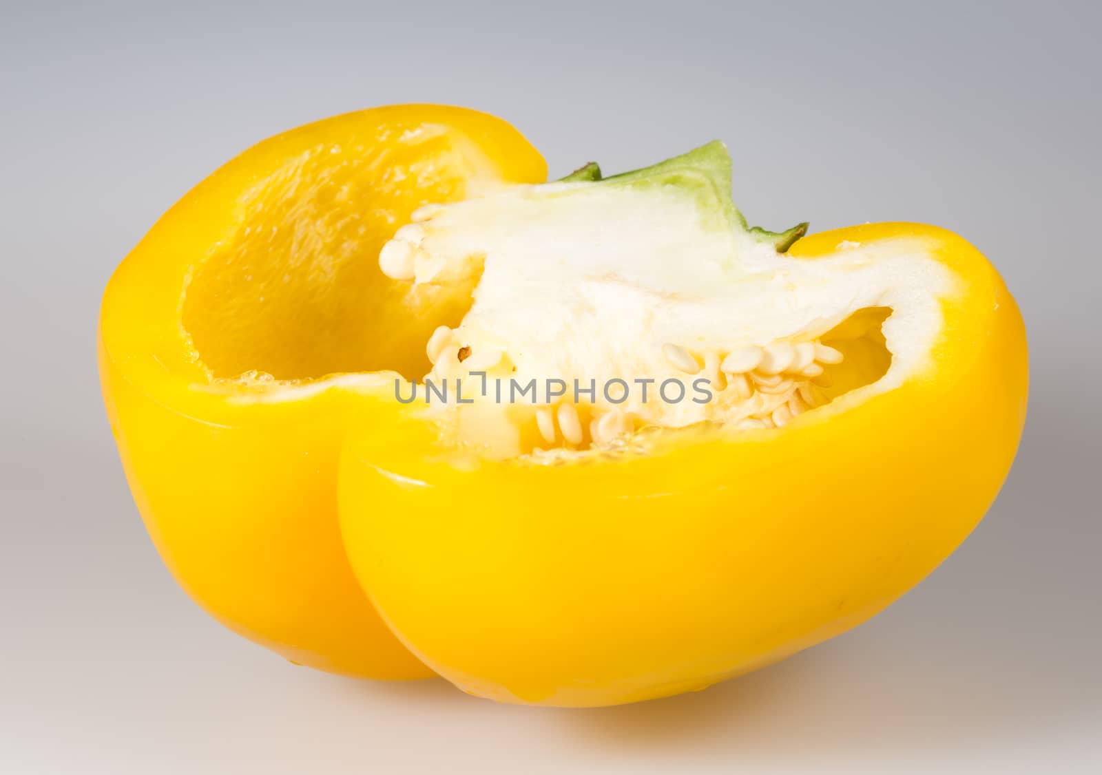 Sliced Yellow Bell Pepper close up on grey background.
