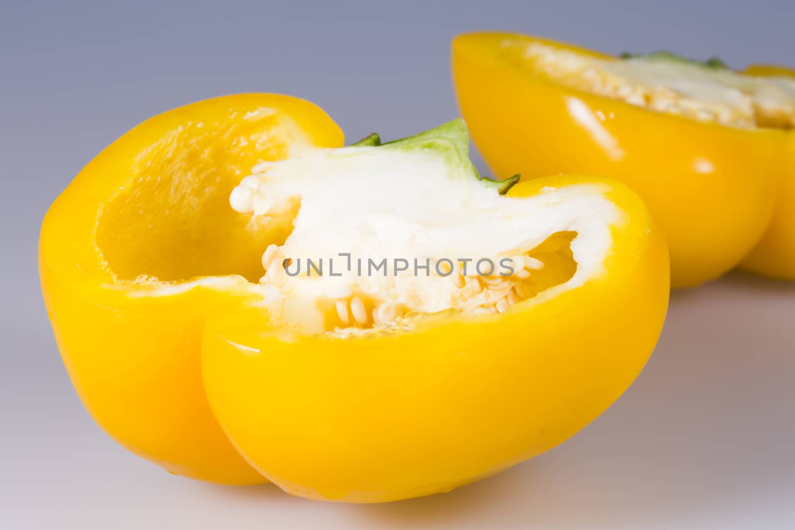 Sliced Yellow Bell Pepper close up on grey background.