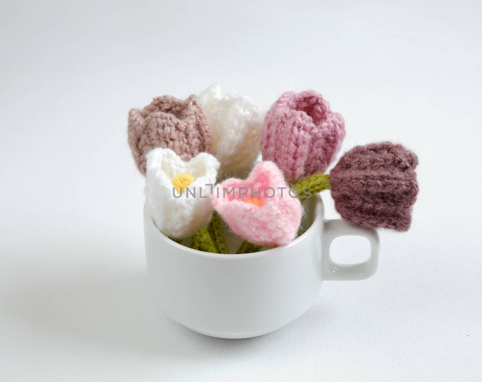 Spring flower for springtime, colorful handmade tulip on white background, diy product by knit can make gift for woman day or mother day