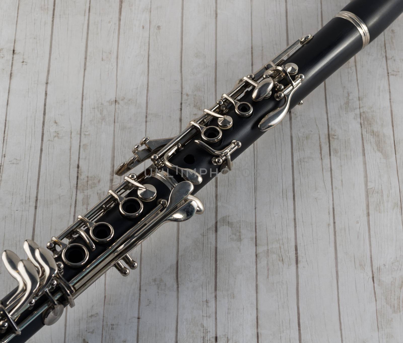 Black clarinet closeup on whitewashed wood background