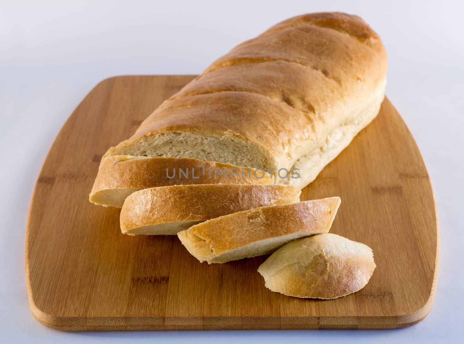 French Bread on Wood Cutting Board by krisblackphotography