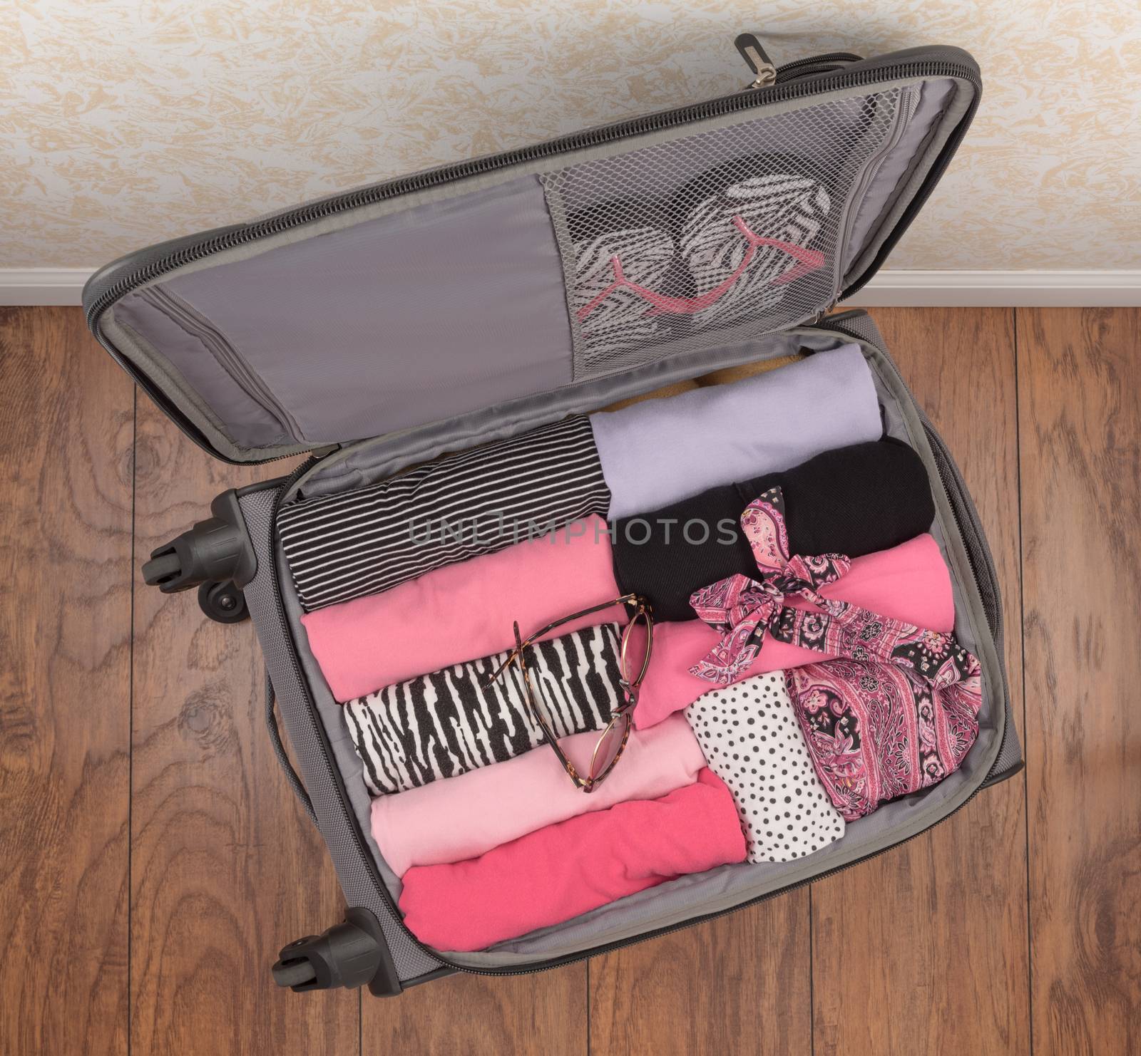 Carry on suitcase packed with ladies clothing