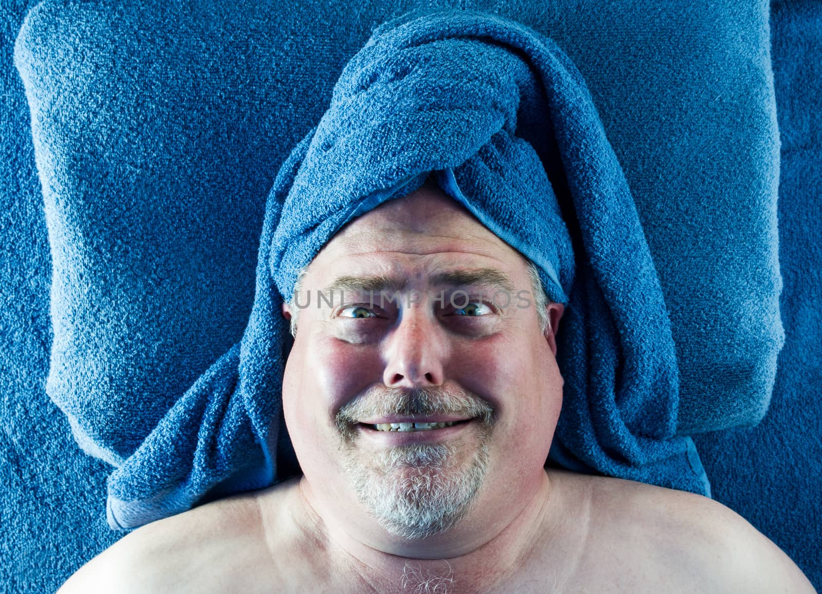 Man at spa with silly facial expression