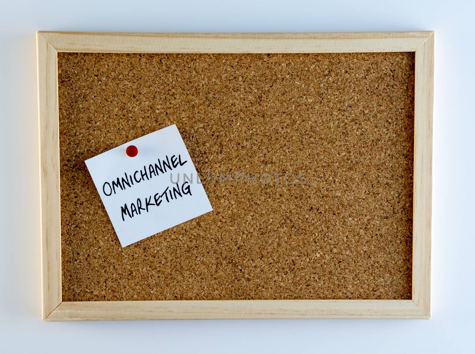 The words, "Omnichannel marketing" pinned on cork bulletin board
