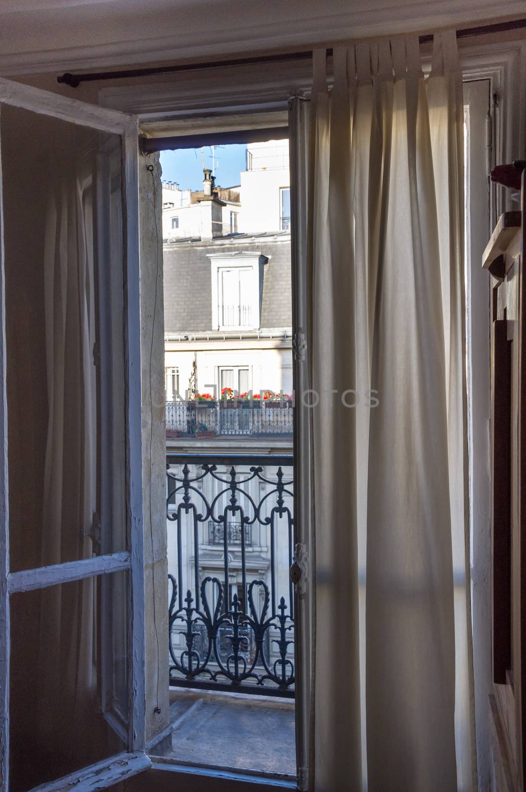 Open apartment window leading to balcony