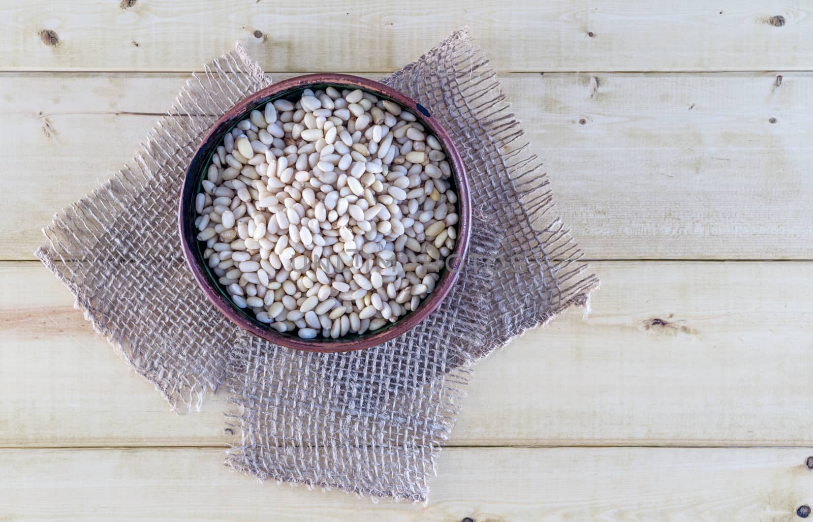 Pine Nuts in Pottery Bowl by krisblackphotography