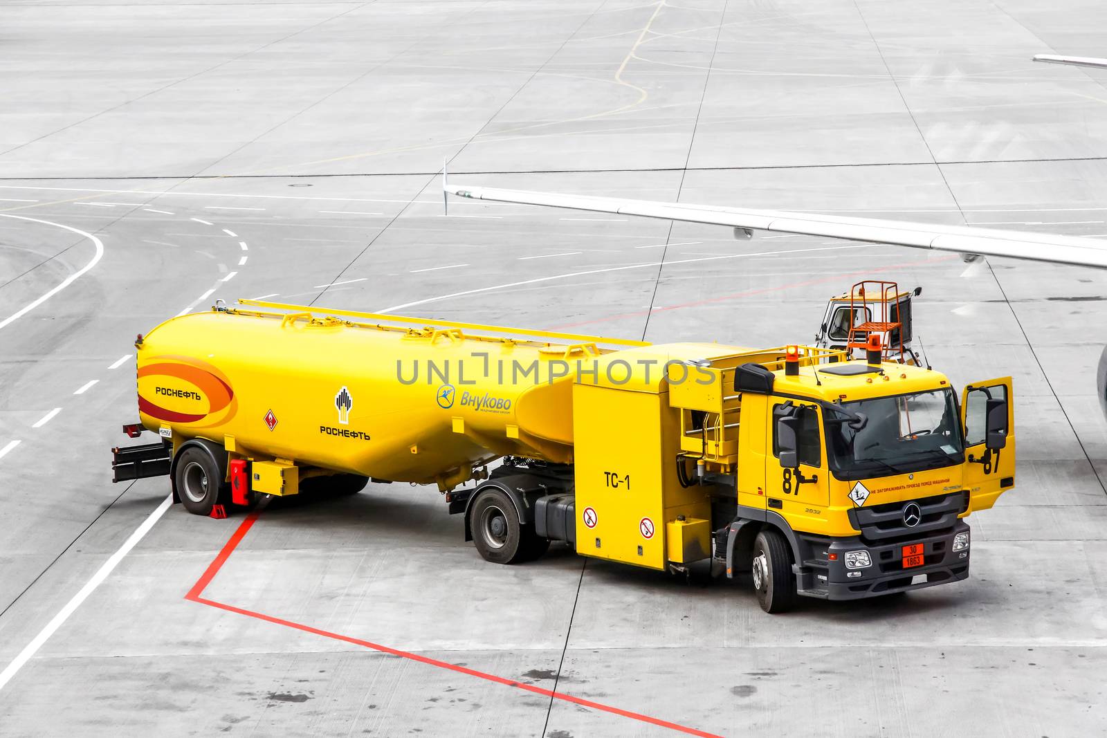 MOSCOW, RUSSIA - SEPTEMBER 9, 2013: Yellow fuel tank truck Mercedes-Benz Actros at the air field of the Vnukovo international airport.