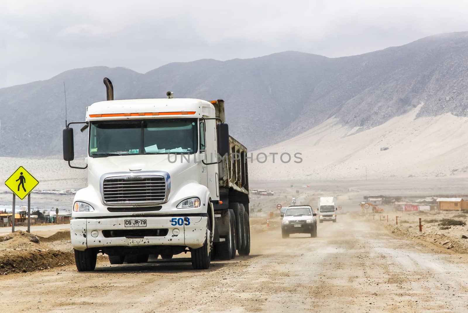 ATACAMA, CHILE - NOVEMBER 14, 2015: Semi-trailer truck Freightliner Columbia at the gravel interurban freeway through the Atacama desert.