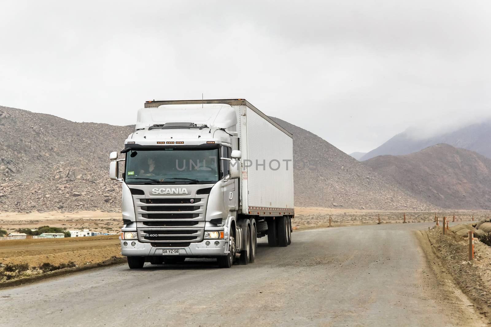 ATACAMA, CHILE - NOVEMBER 14, 2015: Semi-trailer truck Scania R400 at the gravel interurban freeway through the Atacama desert.