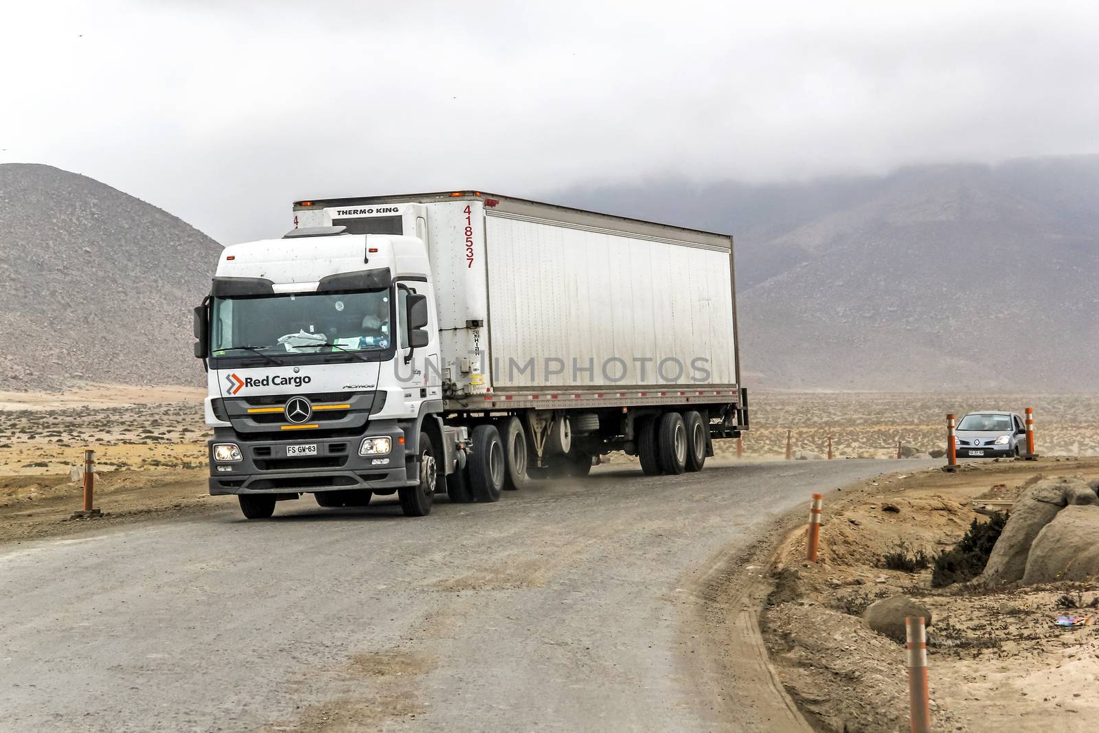 ATACAMA, CHILE - NOVEMBER 14, 2015: Semi-trailer truck Mercedes-Benz Actros at the gravel interurban freeway through the Atacama desert.