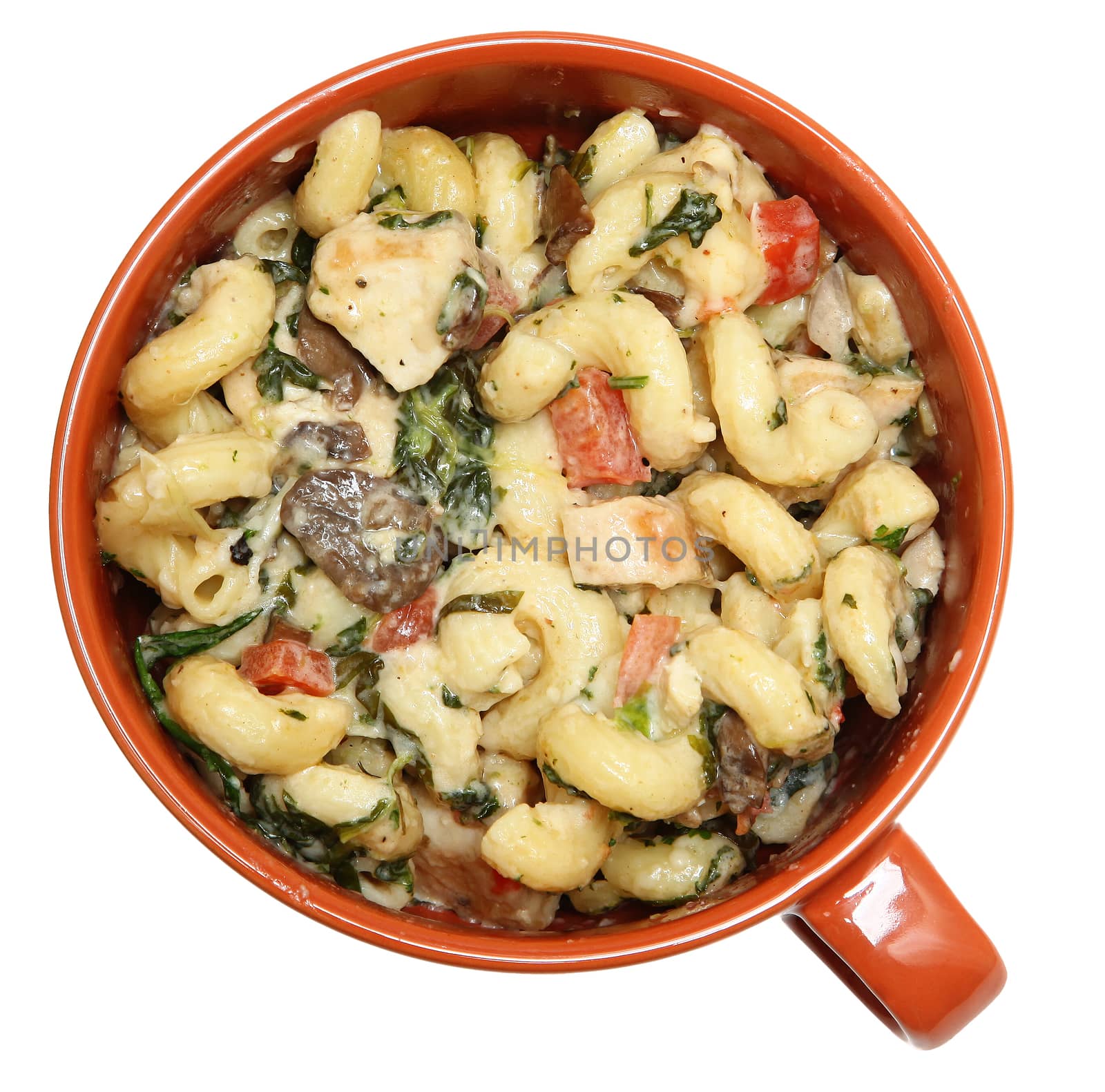 Tuscan Chicken Pasta in Ceramic Bowl isolated over white.