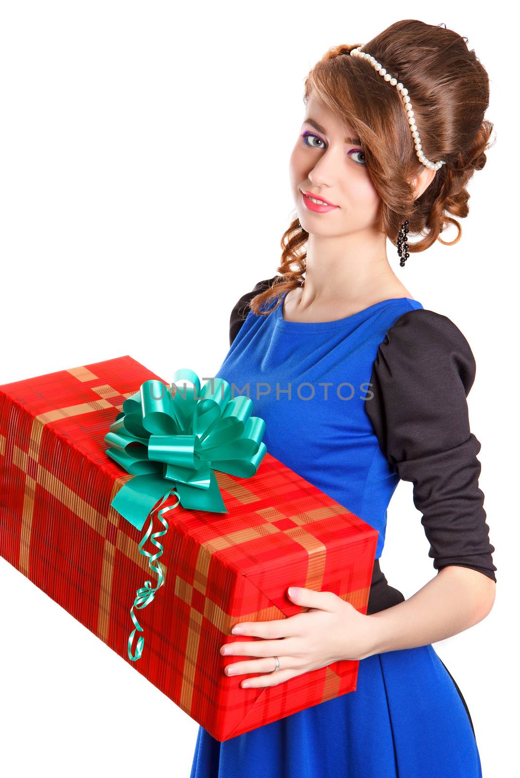 Portrait of a beautiful young woman holding a big gift isolated over white background