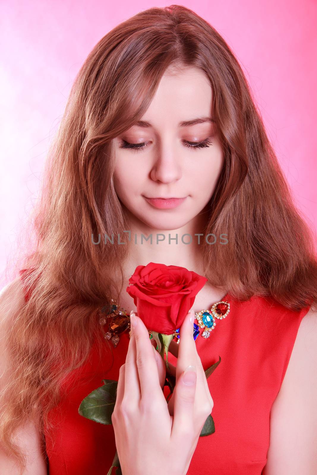 Portrait of a young attractive woman with a red rose by Artzzz