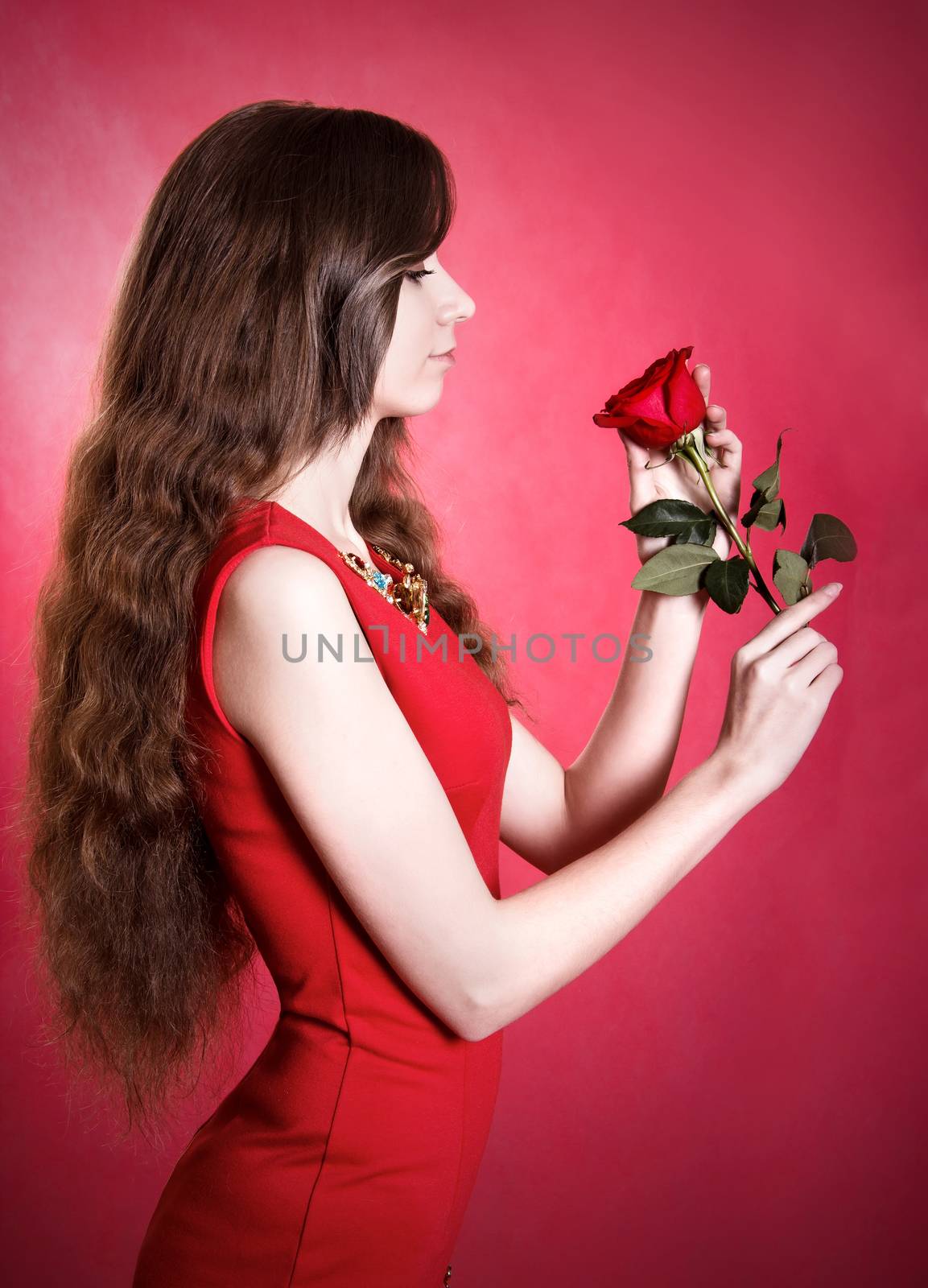 Portrait of a beautiful young woman with a red rose by Artzzz